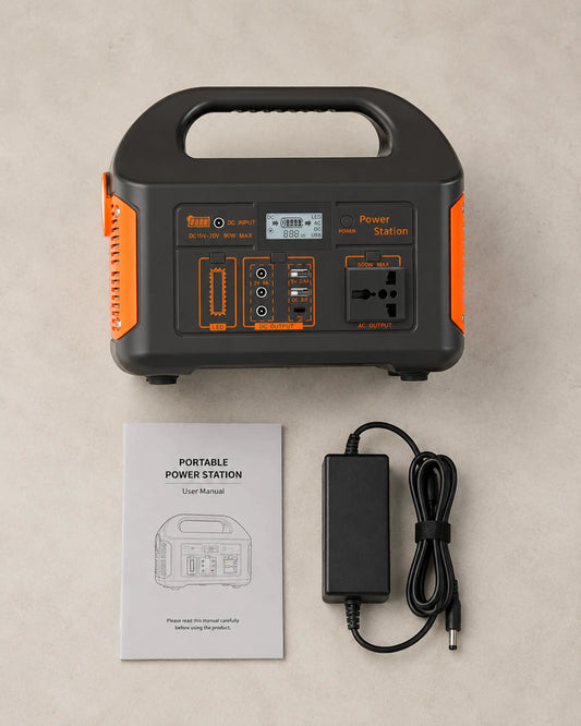 Orange 500W power station with AC charger and manual in an overhead flat lay