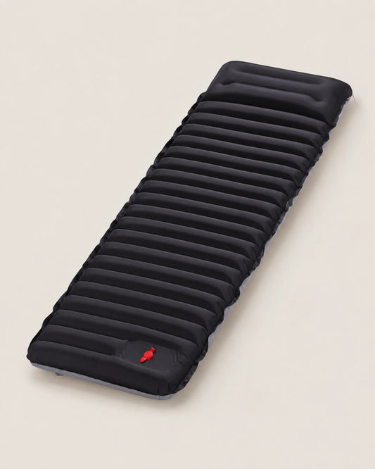 Black with Grey sleeping pad viewed from the left three-quarter studio angle