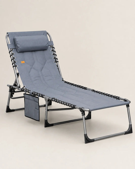 Grey padded folding outdoor chaise lounge shown from the left with bungee-supported seating and steel frame