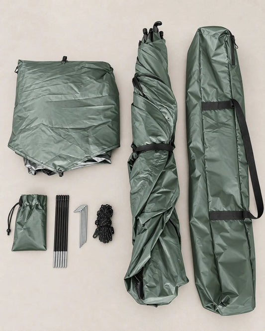 Green quick-opening cabin tent body, frame, carry bag, stakes and guy lines laid flat