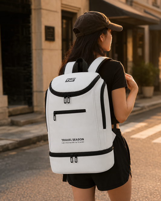 Woman wearing a white Travel Season backpack with black trim on a city street