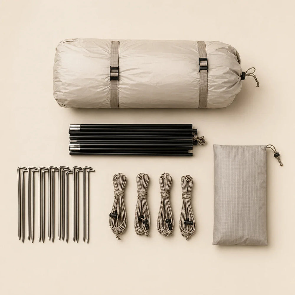 Camping tent packed with poles, stakes and guy lines on a warm neutral background