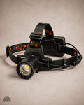 Aluminum LED headlamp angled left view showing lens and headband