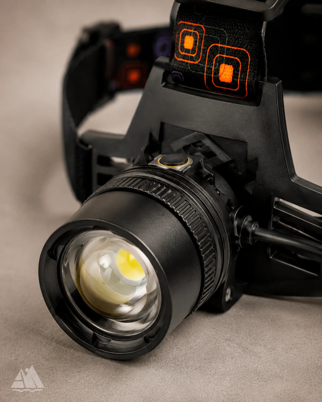 Close-up of LED headlamp lens, zoom ring, and power button