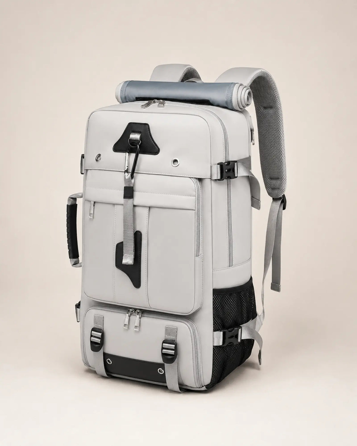 Grey travel backpack, left three-quarter view showing the side carry handle