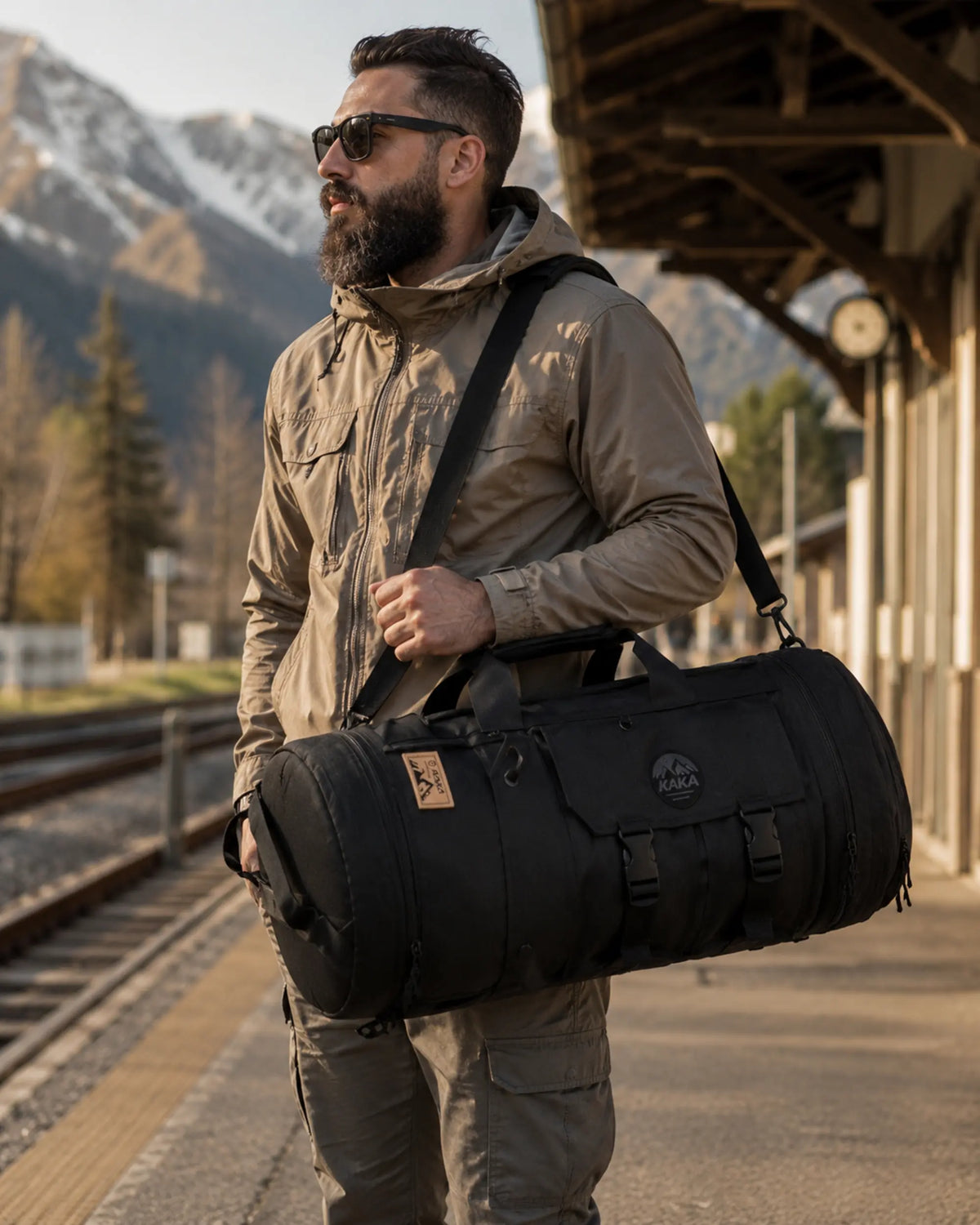 Black multi-carry travel bag carried at a mountain rail platform