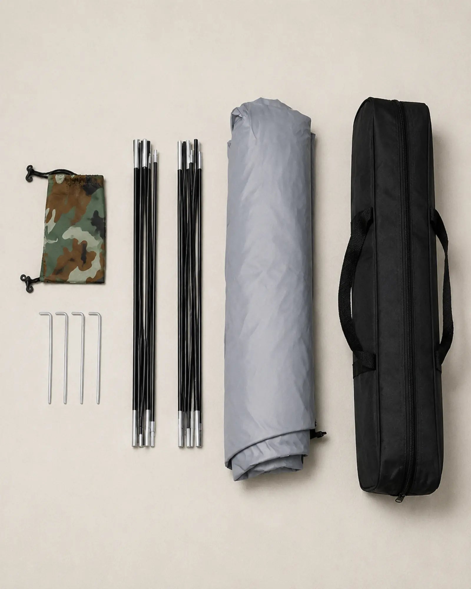 Folded camouflage camping tent with poles stakes pouch and carrying bag