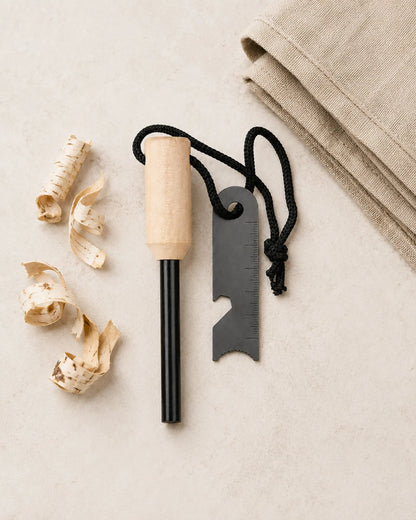 ARWE ferrocerium fire starter flat lay with birch tinder and folded canvas