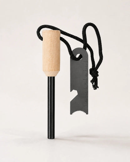 ARWE cylindrical wood-handle ferrocerium fire starter with steel striker on a neutral background