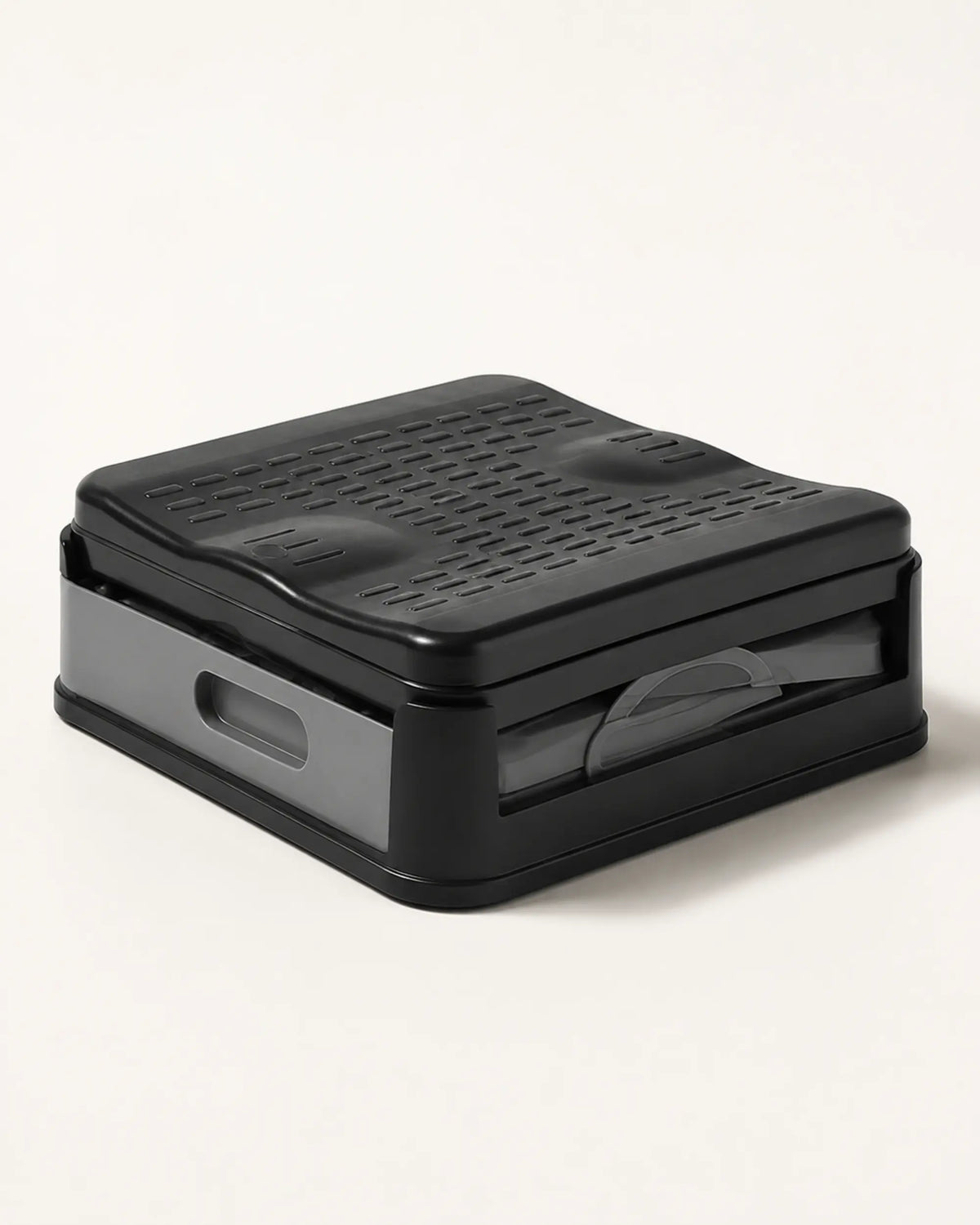Compact folded portable camping toilet in grey and black shown in its low-profile storage configuration