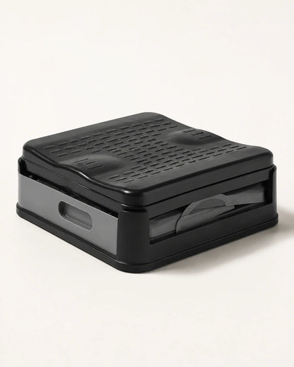Compact folded portable camping toilet in grey and black shown in its low-profile storage configuration