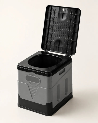 Grey foldable portable camping toilet fully assembled with the black lid raised in a front three-quarter hero view
