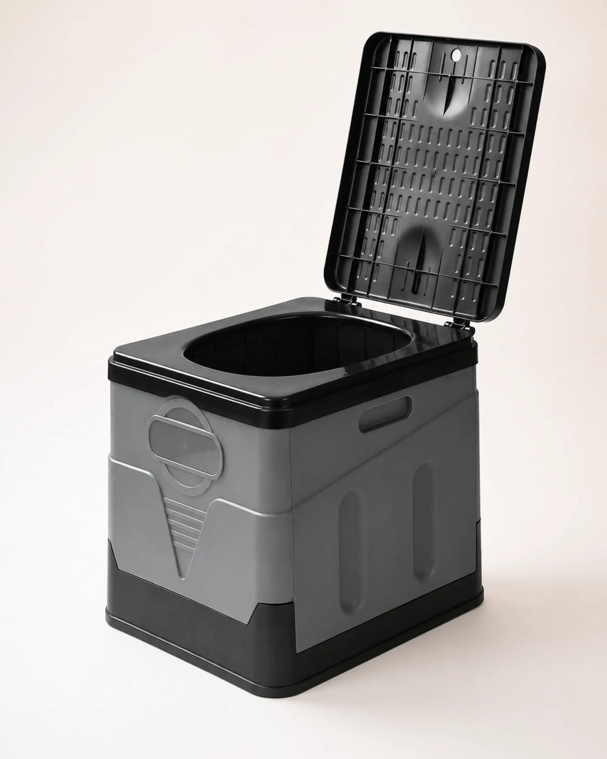 Grey foldable portable camping toilet shown from the right with raised lid, molded panels and carry handle