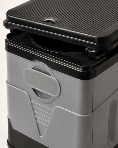 Close-up of the portable camping toilet integrated handle, locking panel seam, black rim and lid hinge