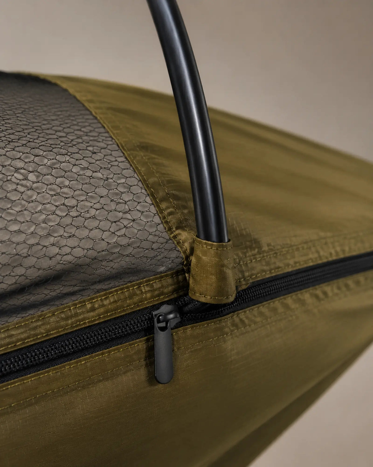 Close-up of the hexagonal mesh zipper seam and support arch connection