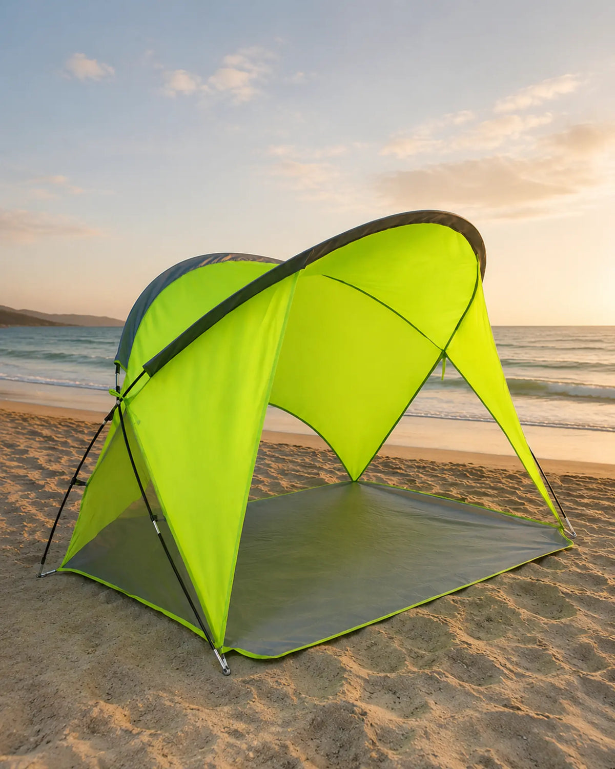 Empty Green beach camping shelter on the sand at sunset