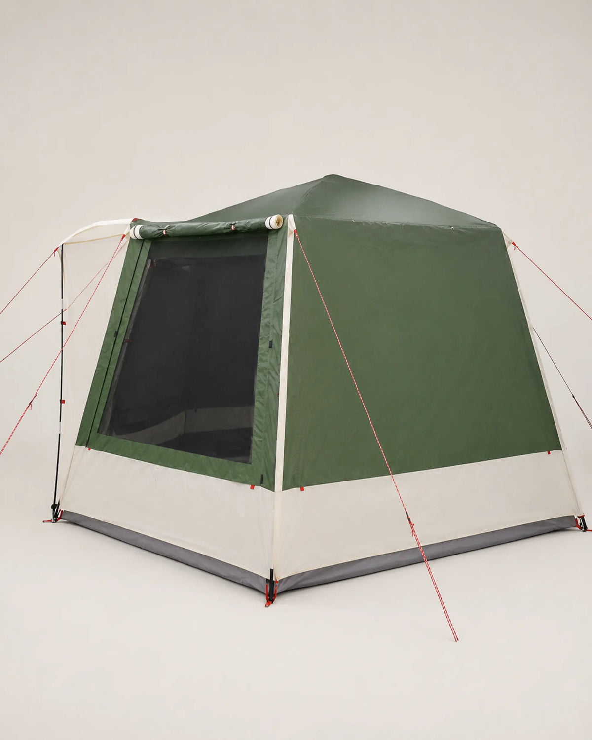 Rear angle of the green family tent with olive panels and white skirt