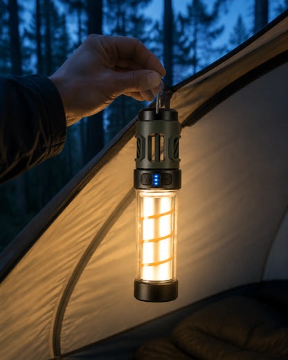Camper hanging an illuminated AH06 LED lantern inside a tent at blue hour