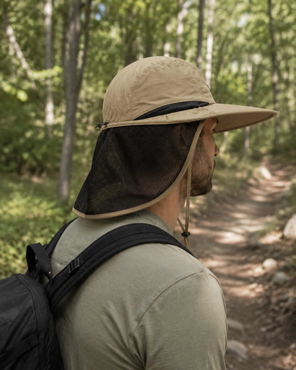 Hiker wearing khaki sun hat with breathable neck flap on woodland trail