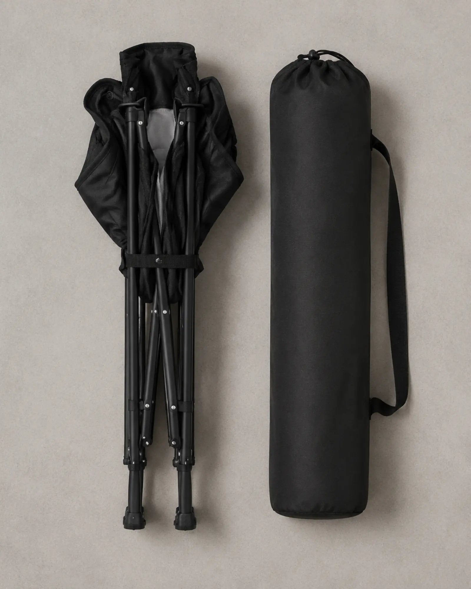 Folded rocking camping chair arranged beside its black carry bag