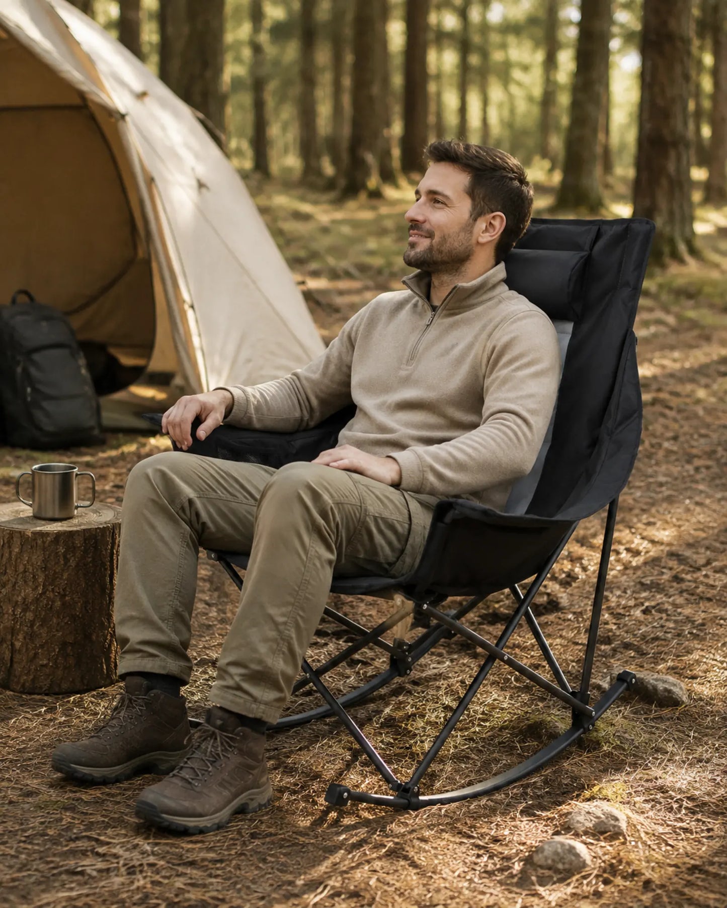 Adult relaxing in the black and grey rocking chair at a campsite