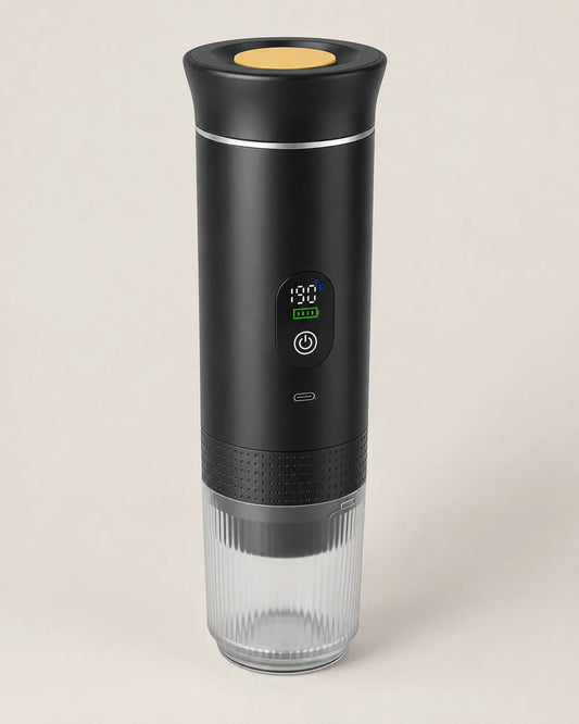 Black portable espresso machine viewed from front left on warm studio background