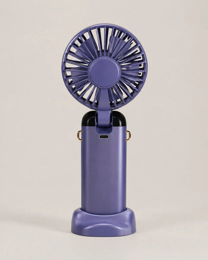Blue portable fan rear view showing grille, hinge, and USB charging port