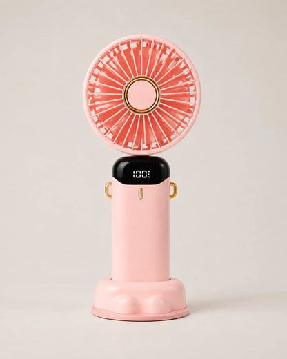 Pink portable fan front view upright on its sculpted desktop base