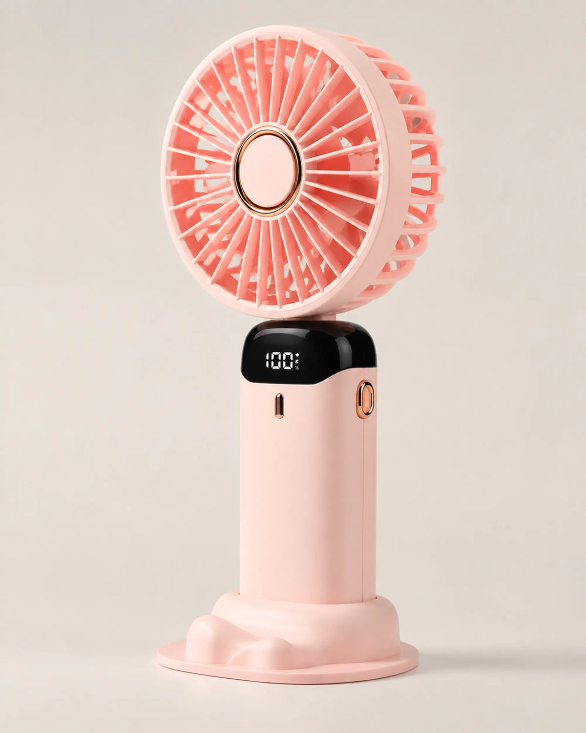 Pink portable fan three-quarter view showing coral grille and gold details