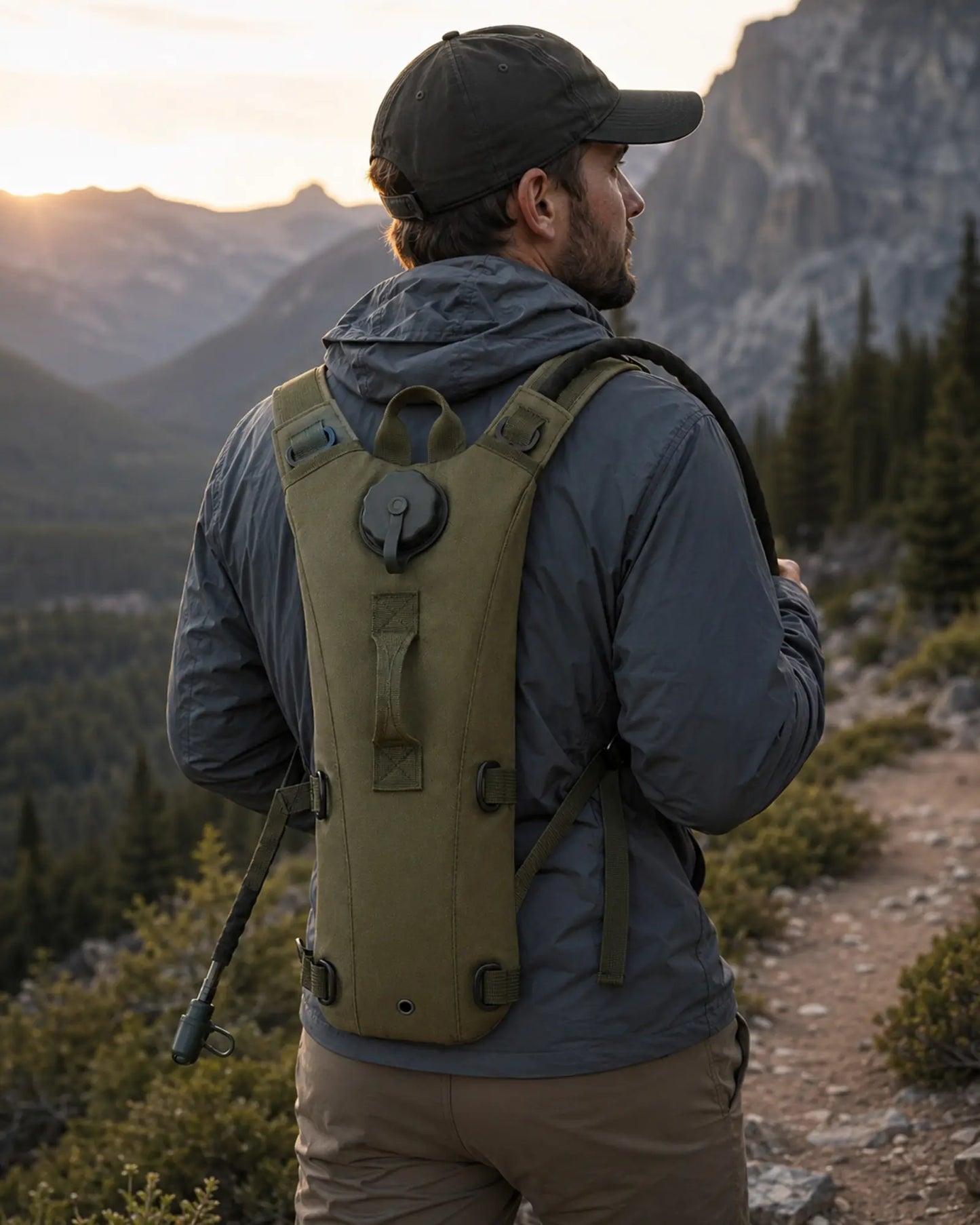 Hiker wearing OD green ARWE hydration backpack on mountain trail