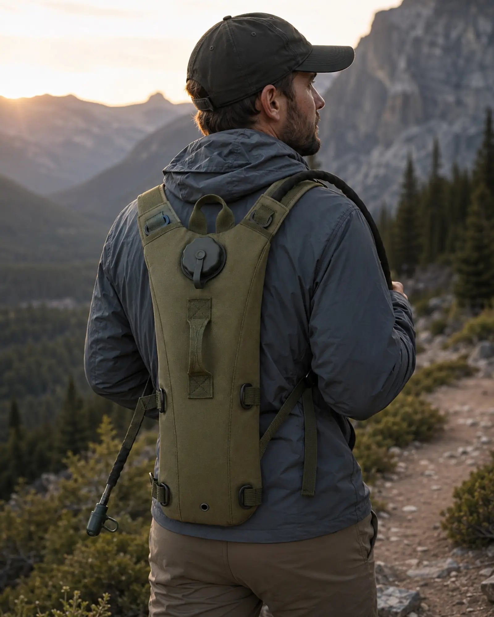 Hiker wearing OD green ARWE hydration backpack on mountain trail