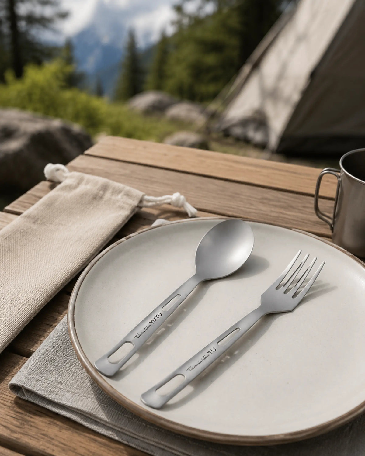 ARWE titanium spoon and fork ready on a mountain campsite table