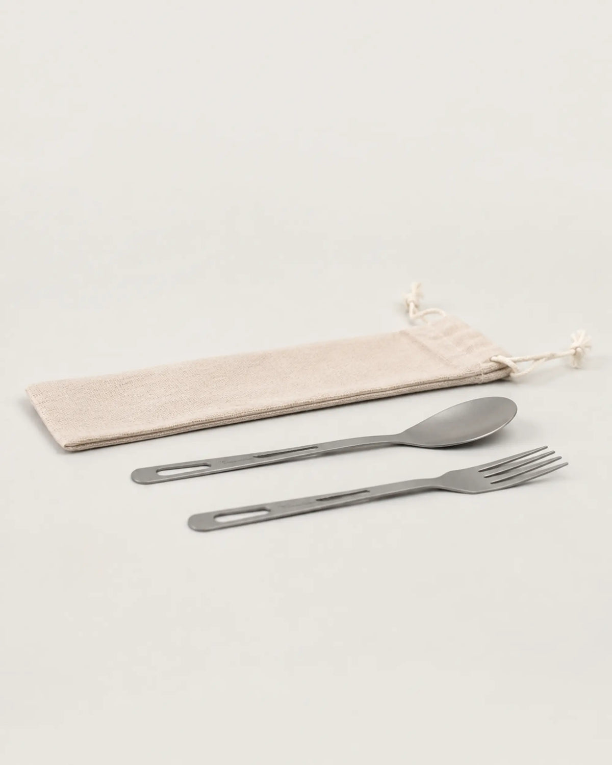 Slim side profile of ARWE titanium spoon fork and travel pouch