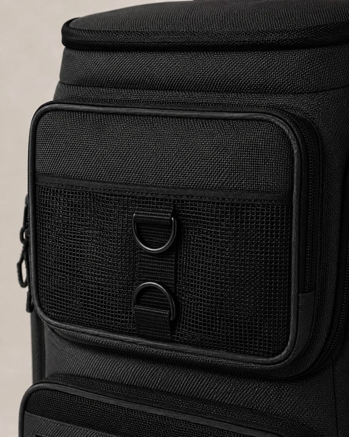 Close-up of black fishing tackle backpack mesh pocket webbing and D-ring hardware