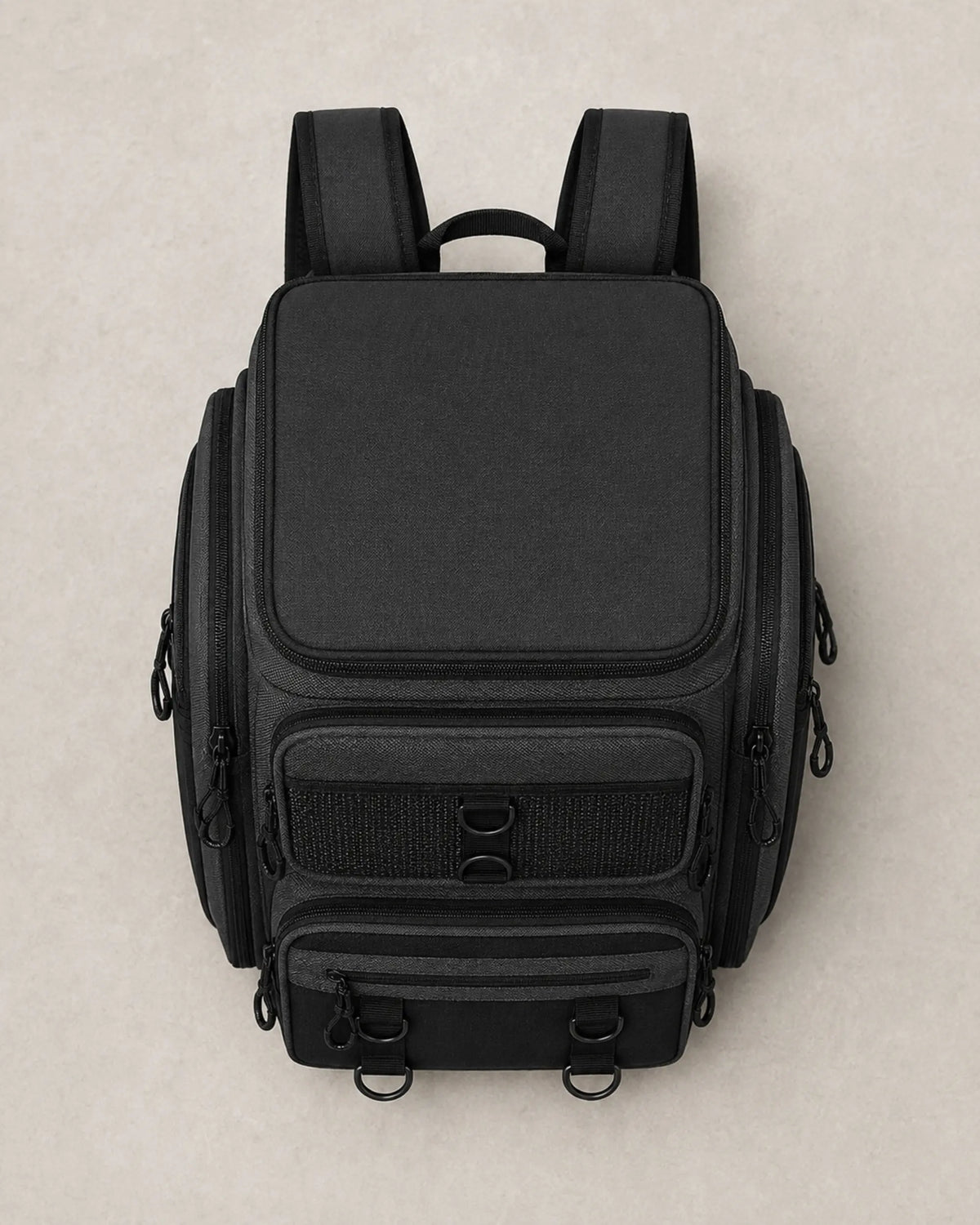 Top view of closed black fishing tackle backpack with zippered lid
