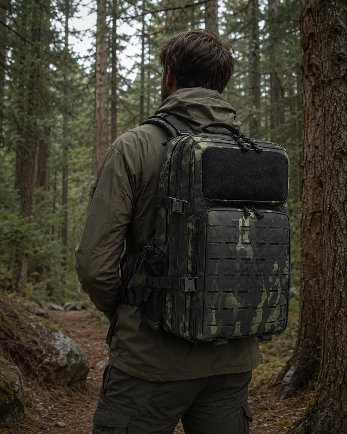 Hiker wearing Black CP camouflage tactical backpack on a forest trail