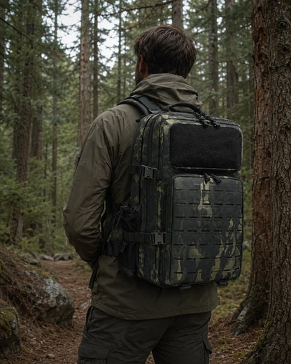 Hiker wearing Black CP camouflage tactical backpack on a forest trail