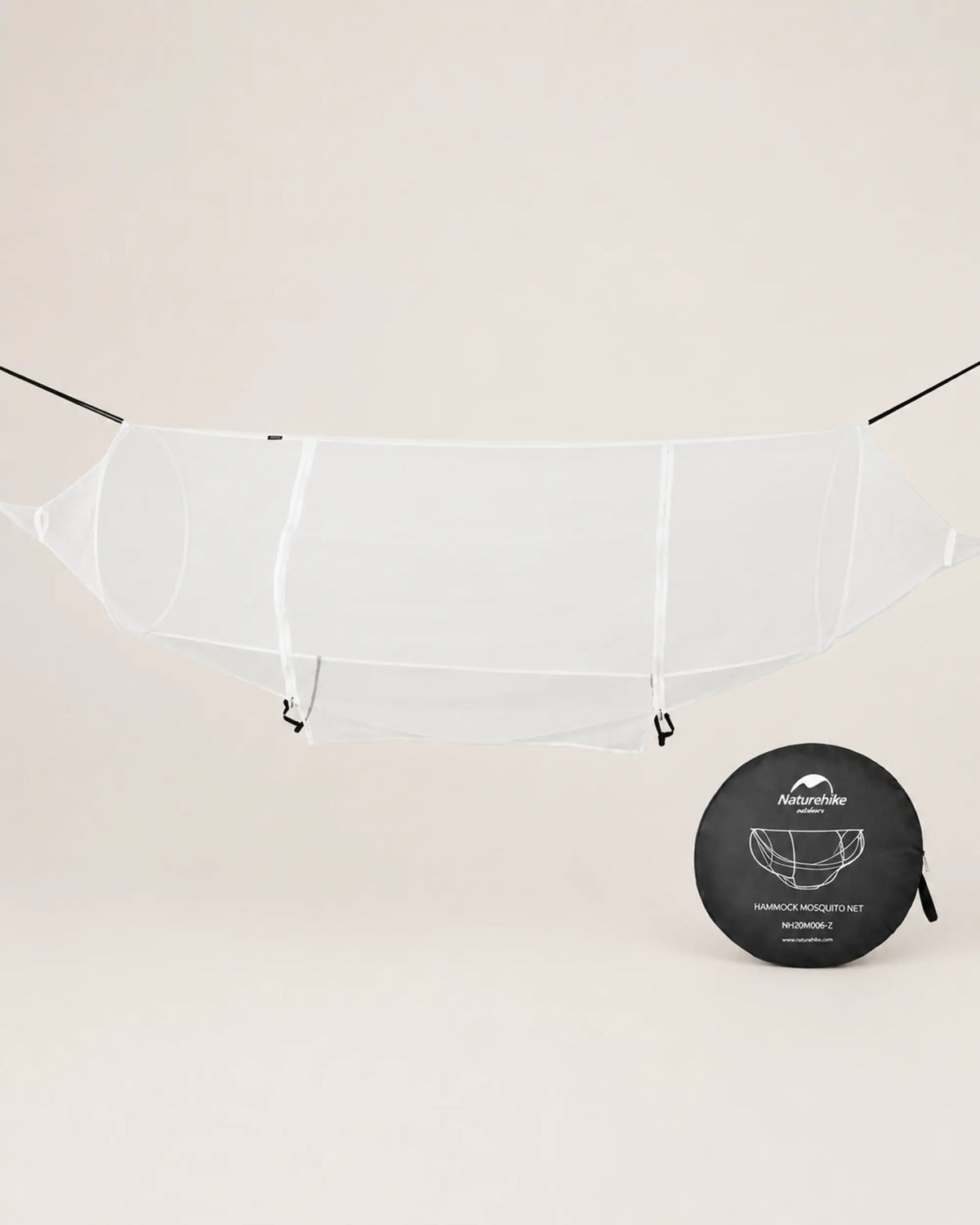 White Naturehike hammock mosquito net suspended beside its round storage bag