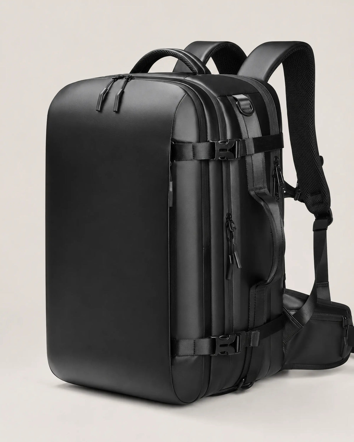 Close view of the black business travel backpack compression buckles and zipper hardware