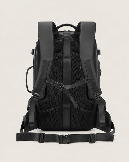 Black business travel backpack rear view with padded shoulder straps and waist belt