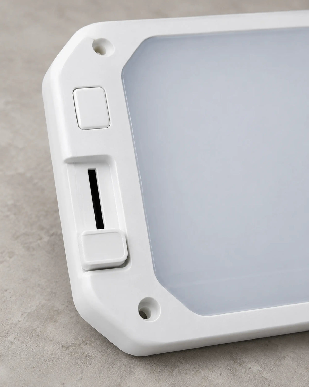Close view of the RV ceiling light mode button and vertical brightness slider