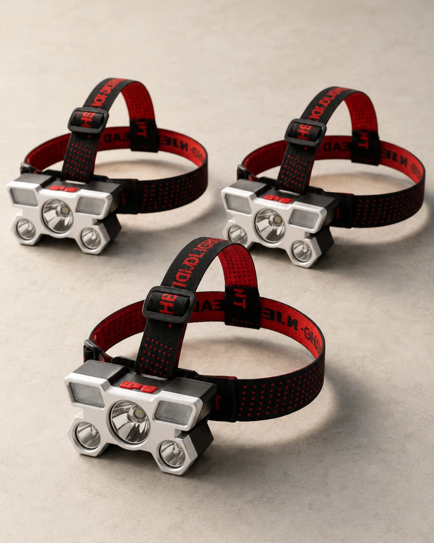 Three T21 Style C rechargeable headlamps with silver housings and red straps