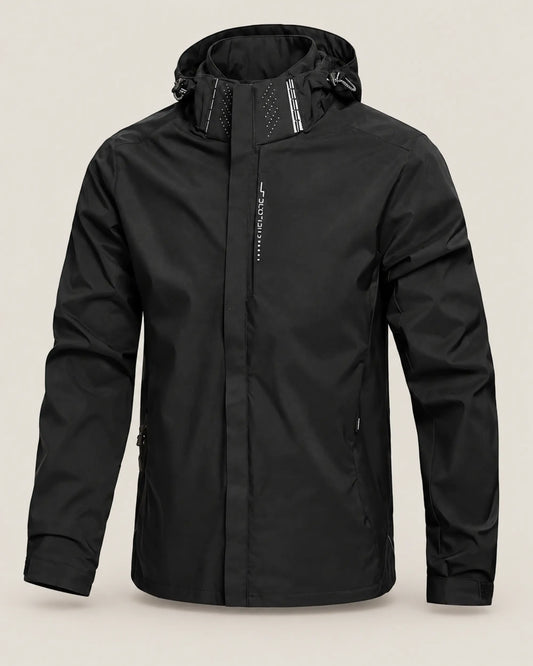 Black men's lightweight waterproof hooded rain jacket shown from the front on a warm stone-grey background.