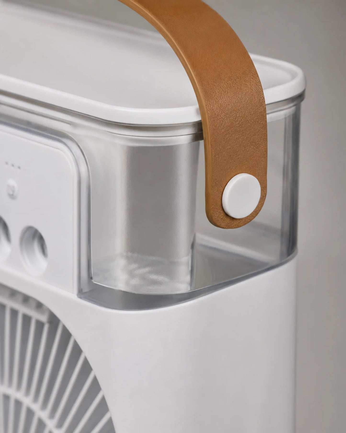 Close-up of the tan carry handle and clear tank on the OIMG white mist fan