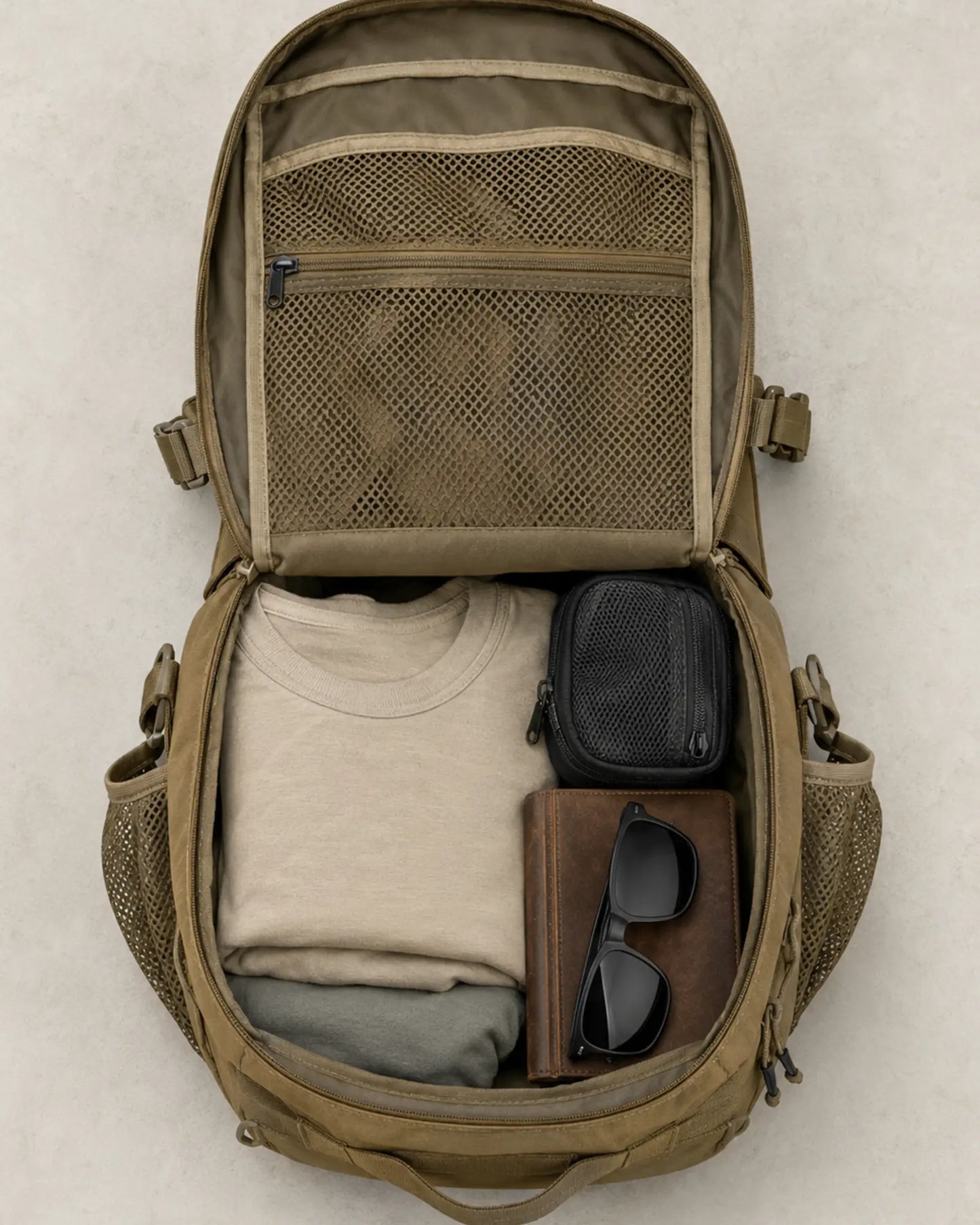 Open Khaki Scione MOLLE backpack showing organized clamshell interior storage