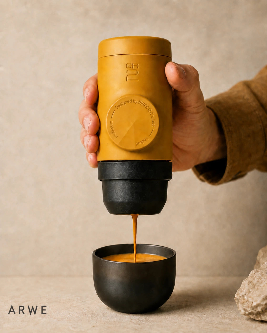WACACO Minipresso GR2 in mustard yellow pouring a fresh espresso shot