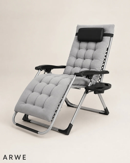 Zero gravity reclining camping chair in gray, angled view with headrest and tray